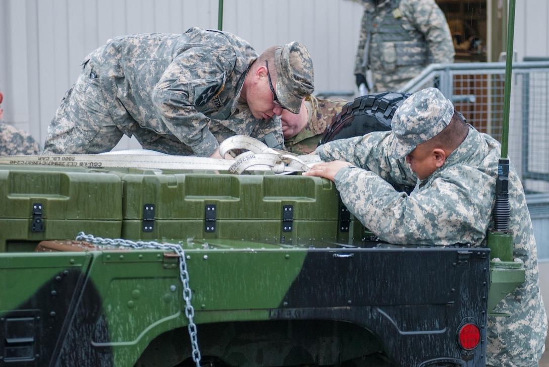 Soldiers from Headquarters and Headquarters Company, 301st Maneuver Enhancement Brigade, prepare a truck to carry cargo before a convoy departs at Joint Base Lewis-McChord, Washington, March 11, 2017. Soldiers from the 301st Maneuver Enhancement Brigade went through a series of maneuver and mobility exercises to ensure deployment readiness and demonstrate the brigade’s ability to command and control in a tactical environment. (U.S. Army Reserve photo by Spc. Sean F. Harding/Released).