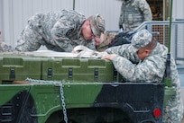 Soldiers from Headquarters and Headquarters Company, 301st Maneuver Enhancement Brigade, prepare a truck to carry cargo before a convoy departs at Joint Base Lewis-McChord, Washington, March 11, 2017. Soldiers from the 301st Maneuver Enhancement Brigade went through a series of maneuver and mobility exercises to ensure deployment readiness and demonstrate the brigade’s ability to command and control in a tactical environment. (U.S. Army Reserve photo by Spc. Sean F. Harding/Released).