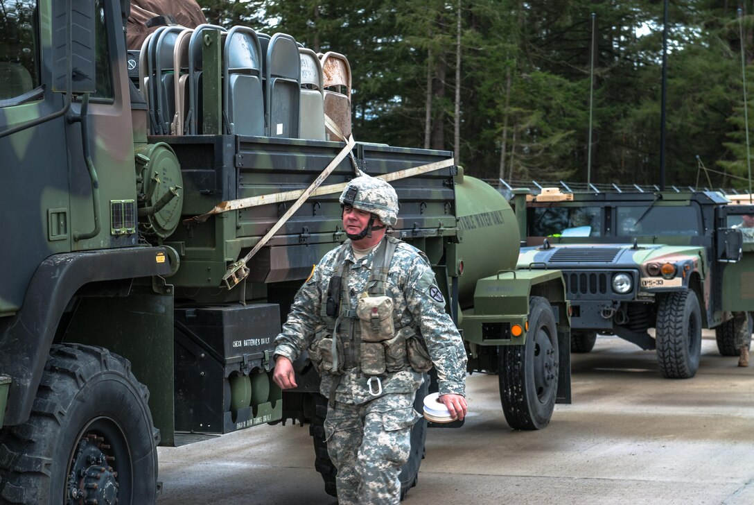 Sgt. Maj. Roy B. Smith inspects vehicles inside of the 301st Maneuver Enhancement Brigade motor pool at Joint Base Lewis-McChord, Washington, March 12, 2017. Soldiers from the 301st Maneuver Enhancement Brigade went through a series of maneuver and mobility exercises to ensure deployment readiness and demonstrate the brigade’s ability to command and control in a tactical environment. (U.S. Army Reserve photo by Spc. Sean F. Harding/Released).