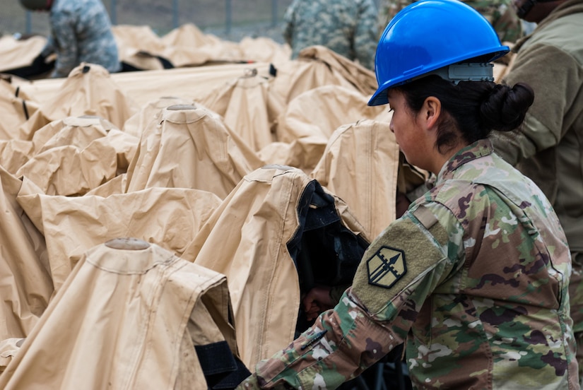 A soldier disassembles a deployable rapid assembly shelter (DRASH) at Joint Base Lewis-McChord, Washington, March 12, 2017. Soldiers from the 301st Maneuver Enhancement Brigade went through a series of maneuver and mobility exercises to ensure deployment readiness and demonstrate the brigade’s ability to command and control in a tactical environment. (U.S. Army Reserve photo by Spc. Sean F. Harding/Released).