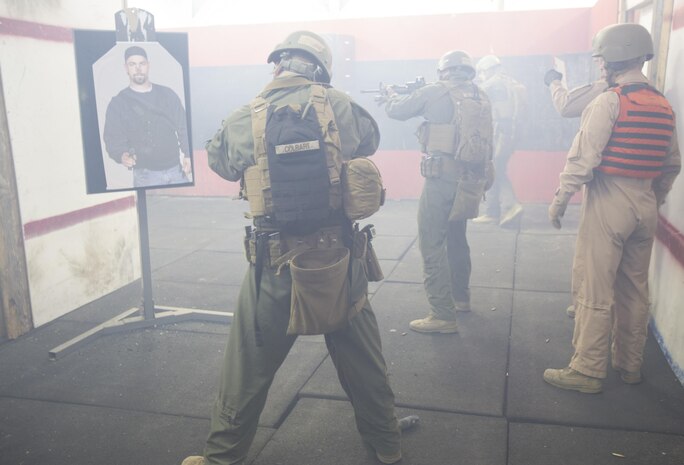 Close Quarters Battle students engage a simulated enemy after dropping a diversionary device during an  being evaluation by the CQB instructors for Phase II of the CQB course, March 3, aboard Naval Support Activity Northwest Annex, Chesapeake, Va. During Phase II, students were taught interior tactics and evaluated daily by their instructors to see how well the students implement their new marksmanship techniques during their clearing exercises. (U.S. Marine Corps photo by Sgt. Kayla D. Rivera/Released.)