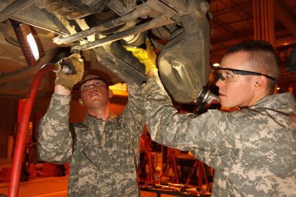 Arizona Army National Guard Pvt. Adam J. Savard and Pvt. Dakota S. Bohl work to remove the half-shaft on an M1097A2 Humvee during an inspection service March 14, 2017, at the TACOM Fleet Management Expansion, Tactical Vehicle Division, on Fort Benning, Georgia. The Soldiers, who are wheeled vehicle mechanics with the 3666th Support Maintenance Company, are at Fort Benning conducting their 15-day annual training. 