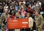 Dr. Isabell Clayton (center), principal of Robert G. Cole Middle and High School, was honored as a finalist for the 2017 H-E-B Excellence in Education Award at a surprise assembly March 7.