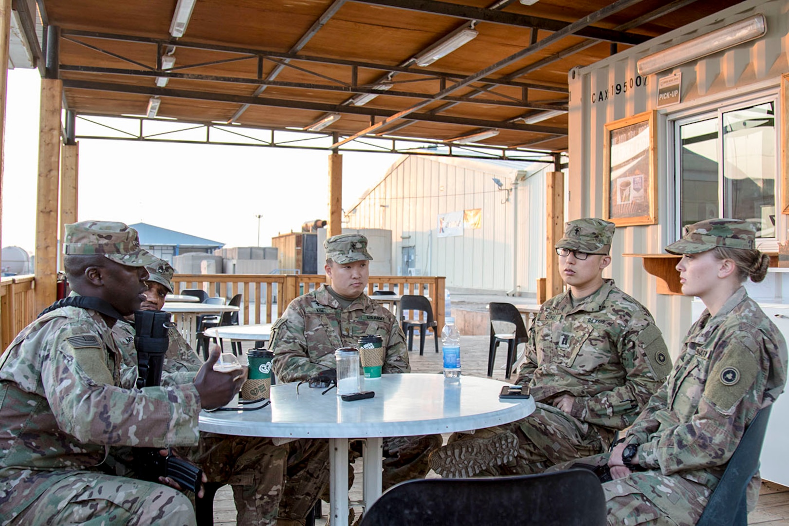 Master Sgt. Samuel W. Gilpin, 1st Theater Sustainment Command, (near left), Staff Sgt. Anthony C. Mills, (center left) and Maj. (CH) James S. Kim, (center), both with the 369th Sustainment Brigade, meet with Capt. Bryan Sunu, (center right) and Spc. Zowie Sprague, (near right), both with the 314th Combat Sustainment Support Battalion, during a Unit Ministry Team battlefield circulation visit in Taji, Iraq, on Feb. 14, 2017. (U.S. Army photo by Sgt. Cesar E. Leon)
