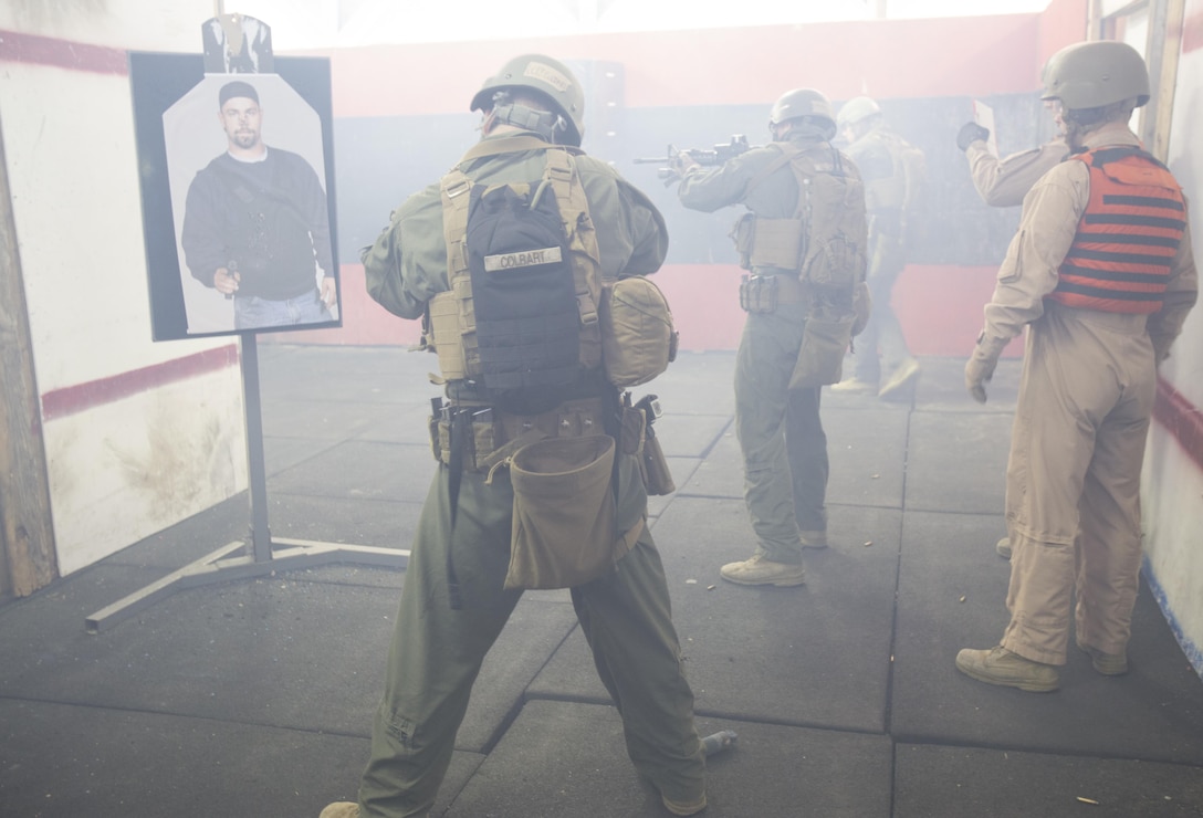 Close Quarters Battle students engage a simulated enemy after dropping a diversionary device during an  being evaluation by the CQB instructors for Phase II of the CQB course, March 3, aboard Naval Support Activity Northwest Annex, Chesapeake, Va. During Phase II, students were taught interior tactics and evaluated daily by their instructors to see how well the students implement their new marksmanship techniques during their clearing exercises. (U.S. Marine Corps photo by Sgt. Kayla D. Rivera/Released.)