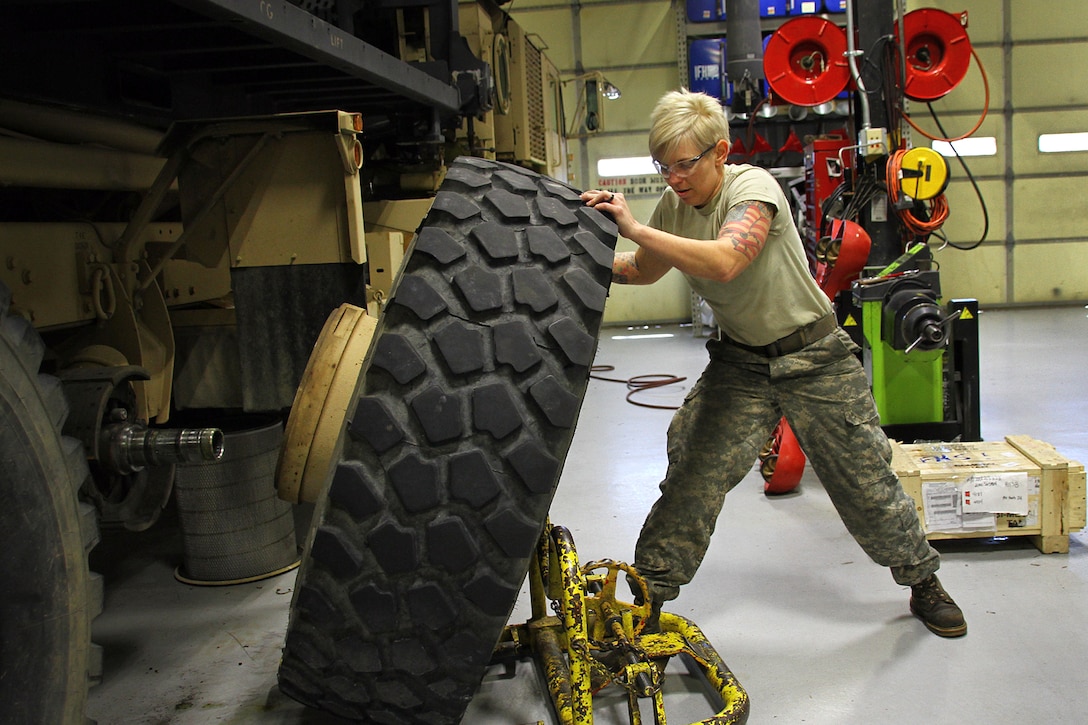 Kentucky Army National Guard Staff Sgt. Kathleen Braithwaite removes a wheel from a M977 Heavy Expanded Mobility Tactical Truck in Frankfort, Ky., March 16, 2017. Kentucky Army National Guard photo by Staff Sgt. Scott Raymond