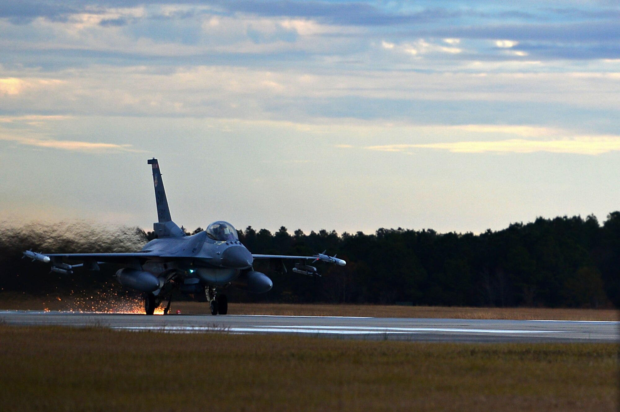 An F-16CM Fighting Falcon assigned to the 77th Fighter Squadron latches onto a Barrier Artillery Kit-12 rotary friction brake aircraft arresting system at Shaw Air Force Base, S.C., Dec. 3, 2016. The arresting systems are tested annually to ensure proper functionality when halting an aircraft in distress. (U.S. Air Force photo by Airman 1st Class Christopher Maldonado)