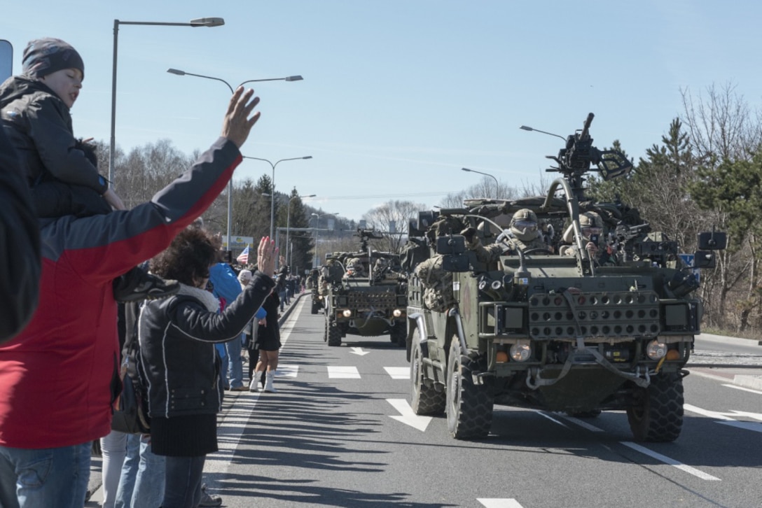 Polish citizens greet the soldiers of Battle Group Poland as the convoy of tactical vehicles crosses the border from the Czech Republic into Poland March 26, 2017. The contingency force of U.S., U.K. and Romanian soldiers convoyed to Orzysz, Poland, where they will integrate with the Polish 15th Mechanized Brigade, 16th Infantry Division. Army photo by Sgt. 1st Class Patricia Deal
