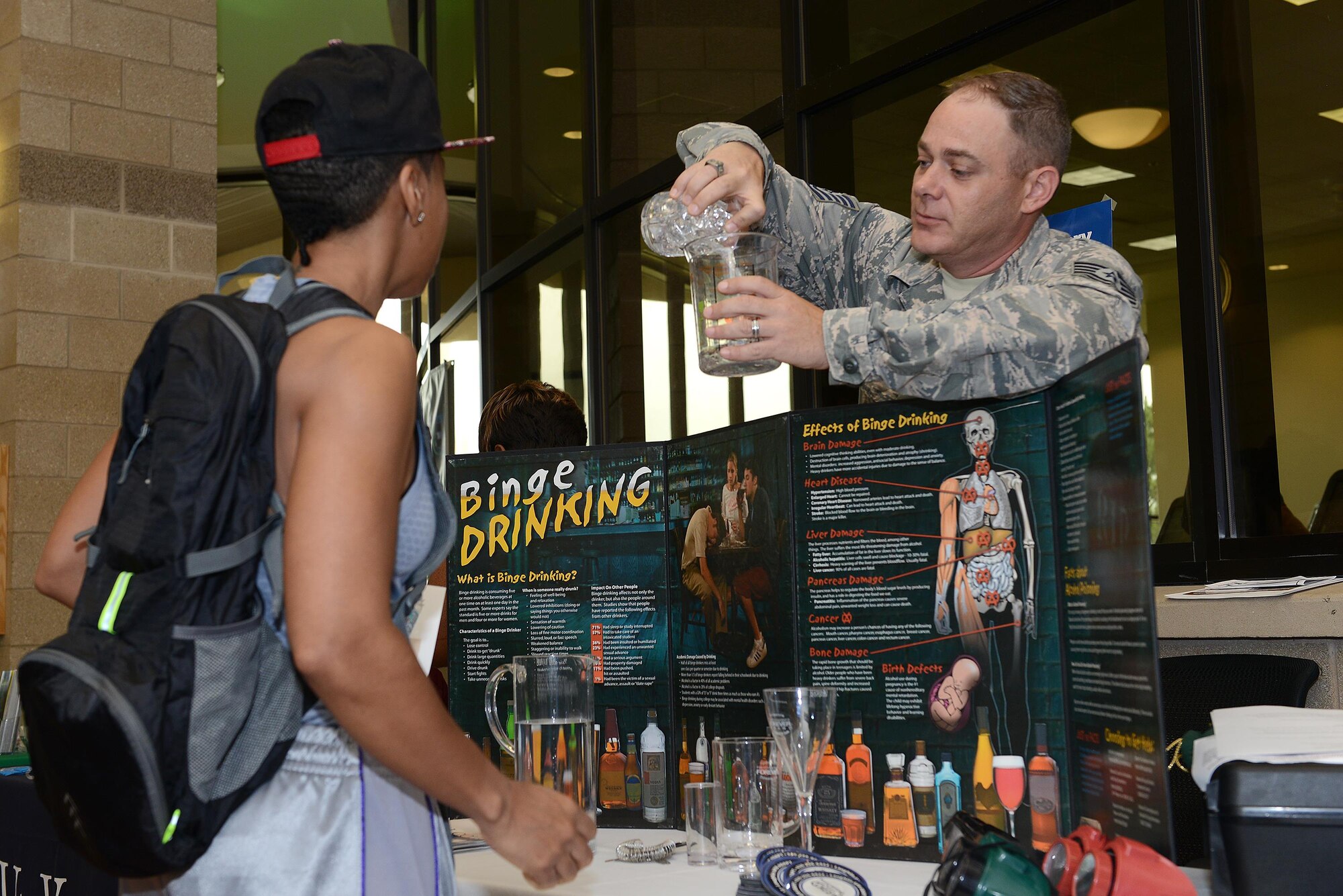 Technical Sgt. Jeremy Bennett, 47th Medical Operations Squadron mental health flight chief, demonstrates common misconceptions with alcohol during a health expo on Laughlin Air Force Base, Texas, March 22, 2017. The health expo brought together various on-base and off-base agencies that promote fitness, heal and wellness. (U.S. Air Force photo/ Airman 1st Class Benjamin N. Valmoja)