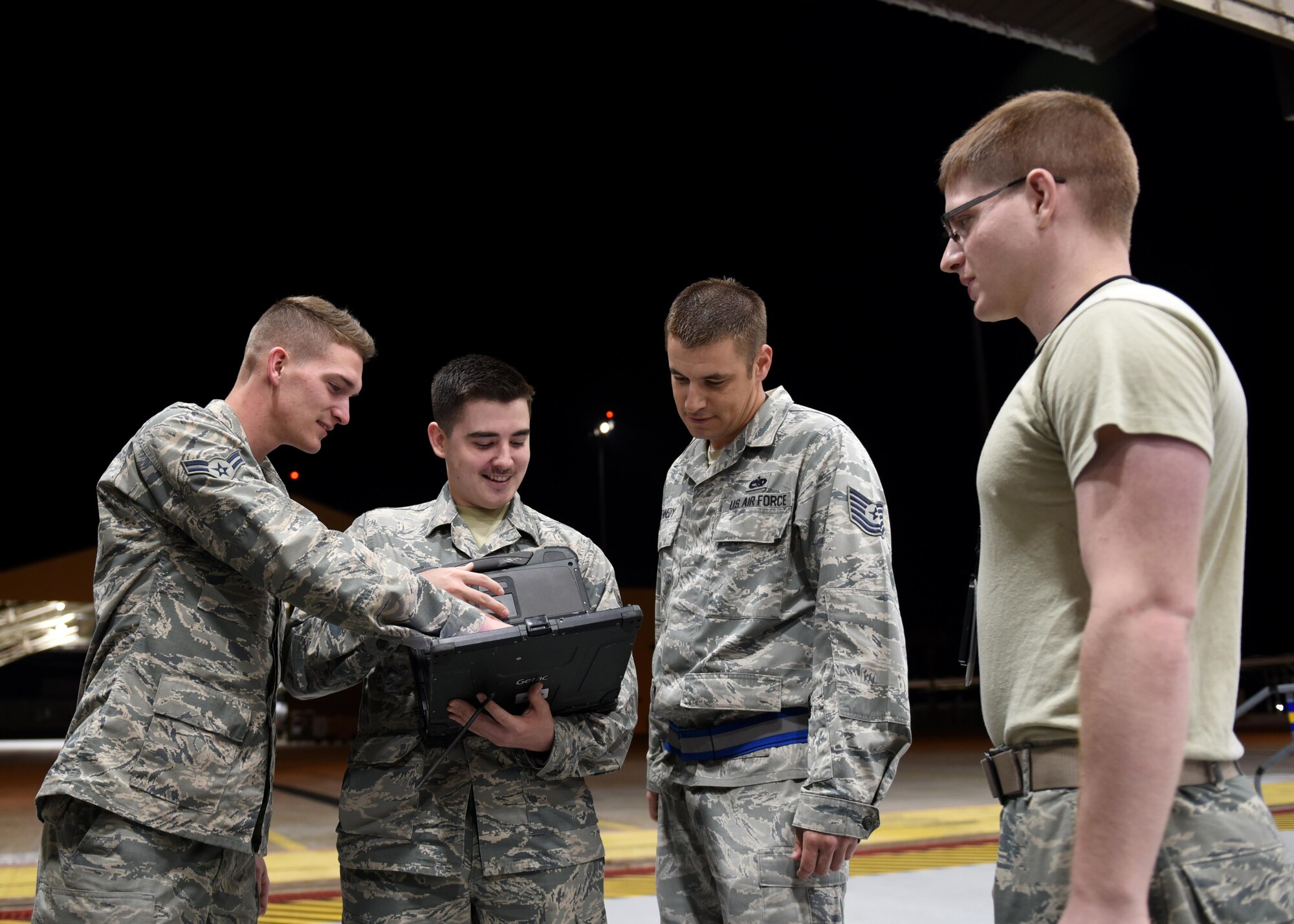 U.S. Air Force Tech. Sgt. Chris Kennedy (second from right), 325th Maintenance Squadron low observables production supervisor, reviews data with his Airmen at Tyndall Air Force Base, Fla., March 20, 2017. Kennedy is a recipient of the Superior Leadership Captain P. Sijan award, which he credits his guidance and care for fellow Airmen.