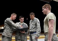 U.S. Air Force Tech. Sgt. Chris Kennedy (second from right), 325th Maintenance Squadron low observables production supervisor, reviews data with his Airmen at Tyndall Air Force Base, Fla., March 20, 2017. Kennedy is a recipient of the Superior Leadership Captain P. Sijan award, which he credits his guidance and care for fellow Airmen.