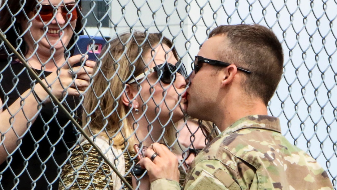 A Virginia Army National Guardsman shares a kiss upon returning to Roanoke, Va., March 25, 2017, following a deployment. Soldiers assigned to the 1st Battalion, 116th Infantry Brigade Combat Team returned from Qatar, where they conducted security operations beginning in May 2016. Army National Guard photo by Cotton Puryear