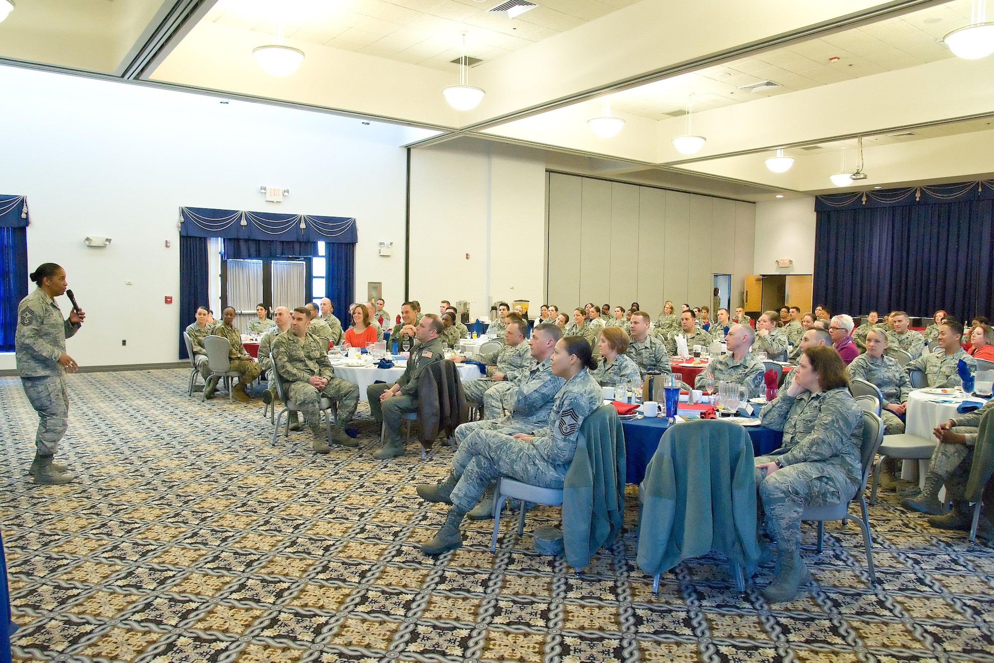 Team Dover members listen to Chief Master Sgt. Shelina Frey, command chief for Air Mobility Command, Scott Air Force Base, Ill., speak at the Women’s History Month Breakfast, March 20, 2017, at The Landings on Dover Air Force Base, Del. Frey was the guest speaker for the event and noted the importance of her having good mentors during her Air Force career. (U.S. Air Force photo by Roland Balik)
