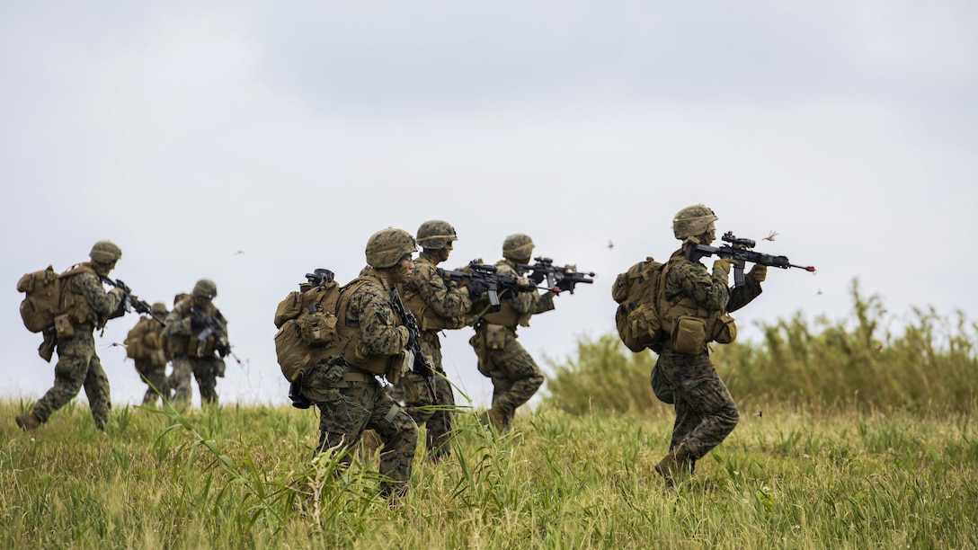 Marines rush an enemy position during an assault as part of a certification exercise on Le Shima Island, Japan, March 24, 2017.  The Expeditionary Operations Training Group conducted the exercise, which involved vertical assault raids, humanitarian assistance and disaster relief training. The Marines are assigned to Golf Company, 2nd Battalion, 5th Marine Regiment, 3r1st Marine Expeditionary Unit, 3rd Marine Expeditionary Force. Marine Corps photo by Lance Cpl. Charles Plouffe