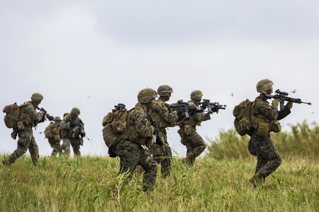 Marines rush an enemy position during an assault as part of a certification exercise on Le Shima Island, Japan, March 24, 2017.  The Expeditionary Operations Training Group conducted the exercise, which involved vertical assault raids, humanitarian assistance and disaster relief training. The Marines are assigned to Golf Company, 2nd Battalion, 5th Marine Regiment, 3r1st Marine Expeditionary Unit, 3rd Marine Expeditionary Force. Marine Corps photo by Lance Cpl. Charles Plouffe