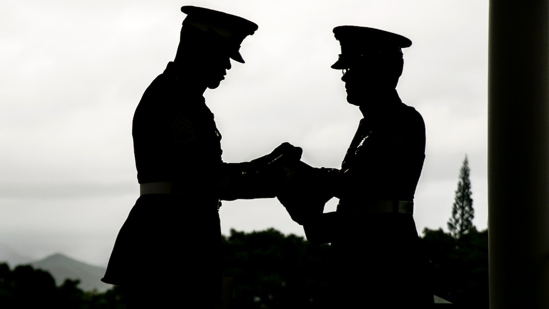 Marine Corps Staff Sgt. Kendrix D. Graham and Sgt. Michael J. Black fold an American flag during the memorial service for retired Marine Corps Col. Vincil W. Hazelbaker at Hawaiian Memorial Park Cemetery in Kaneohe, Hawaii, March 24, 2017. After the ceremony, Marine helicopters conducted a missing man formation for the aviator who served 34 years in the military. Hazelbaker flew more than 680 combat missions and earned the Navy Cross for heroism during the Vietnam War. Marine Corps photo by Sgt. Brittney Vella