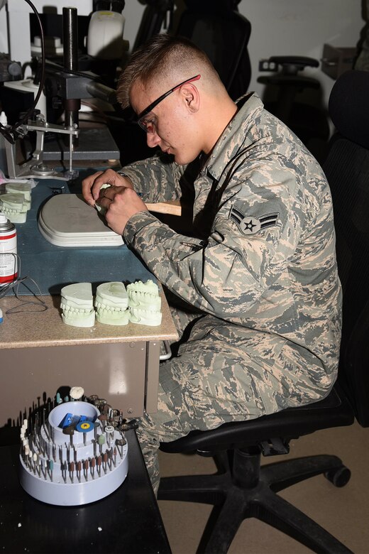 Airman 1st Class Louis Lee, 21st Dental Squadron dental laboratory technician, equilibrates the cast of a patient’s mouth at the dental laboratory March 25, 2017, Peterson Air Force Base, Colo. Occlusal equilibration is a gentle procedure that allows lower teeth to contact upper teeth evenly throughout the mouth. (U.S. Air Force photo by Robb Lingley)