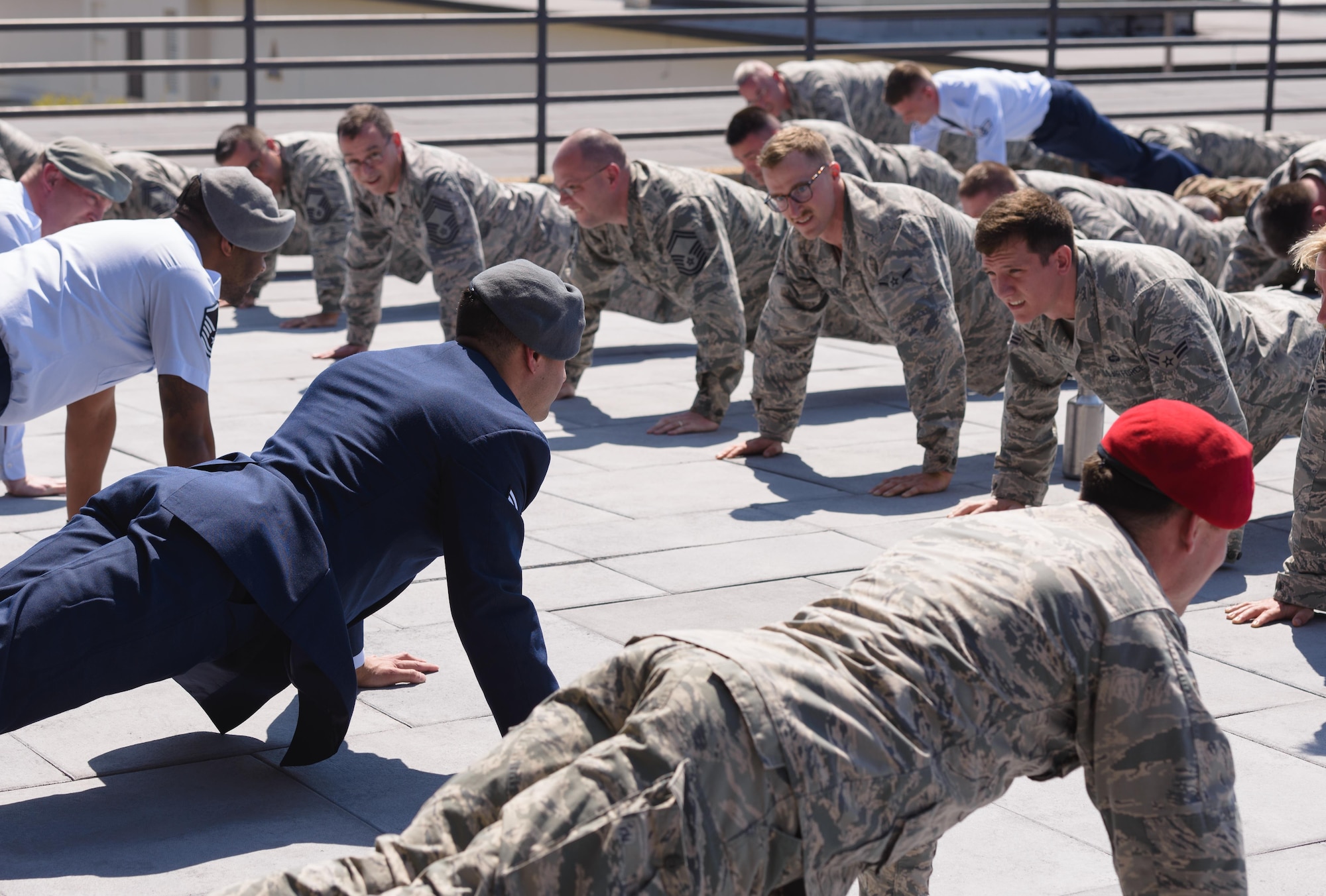 Senior Airman Matthew James, 335th Training Squadron student, leads graduates and guest in Memorial Pushups after receiving his Gray Beret during a Special Operations Weather Apprentice Course graduation ceremony at the Weather Training Complex, March 22, 2017, on Keesler Air Force Base, Miss. At his graduation James received his Gray Beret. (U.S. Air Force photo by Andre’ Askew)
