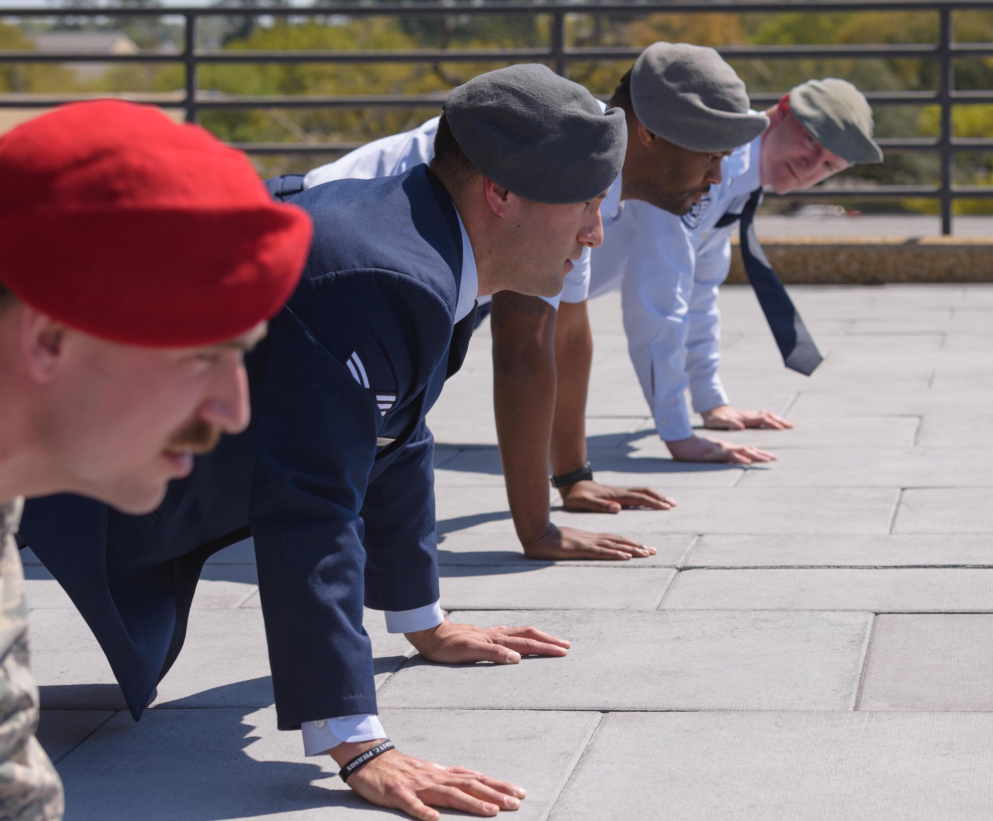 Senior Airman Matthew James, 335th Training Squadron student, leads graduates and guest in Memorial Pushups during a Special Operations Weather Apprentice Course graduation ceremony at the Weather Training Complex, March 22, 2017, on Keesler Air Force Base, Miss. At his graduation James received his Gray Beret. (U.S. Air Force photo by Andre’ Askew) 