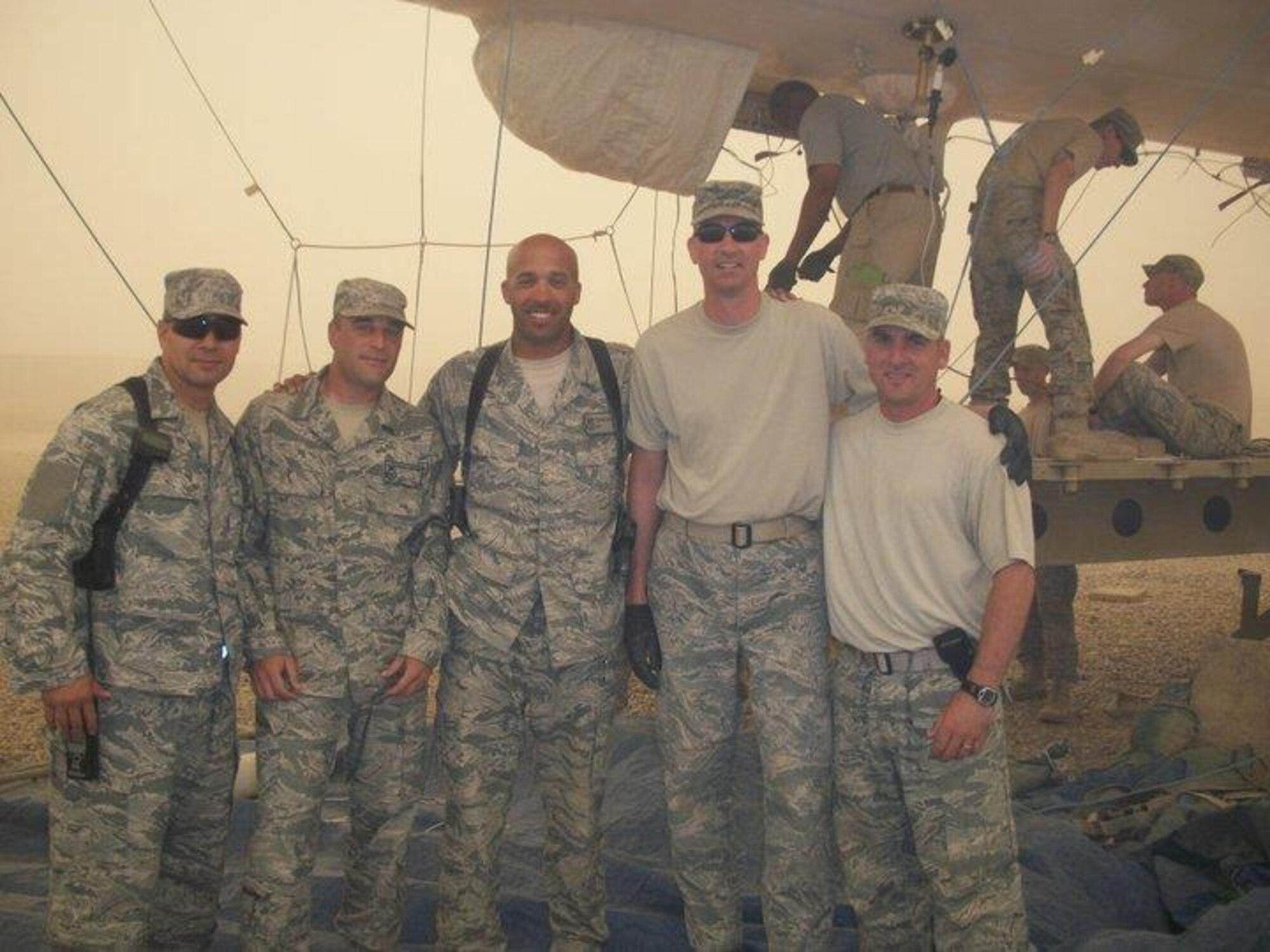 Tech. Sgt. Terrance Williams, center, currently 22nd Security Forces Squadron resources NCO in-charge, poses for a photo July 2011, in Balad, Iraq. Williams deployed nine times during his career, six of which were to combat locations. (Courtesy photo)