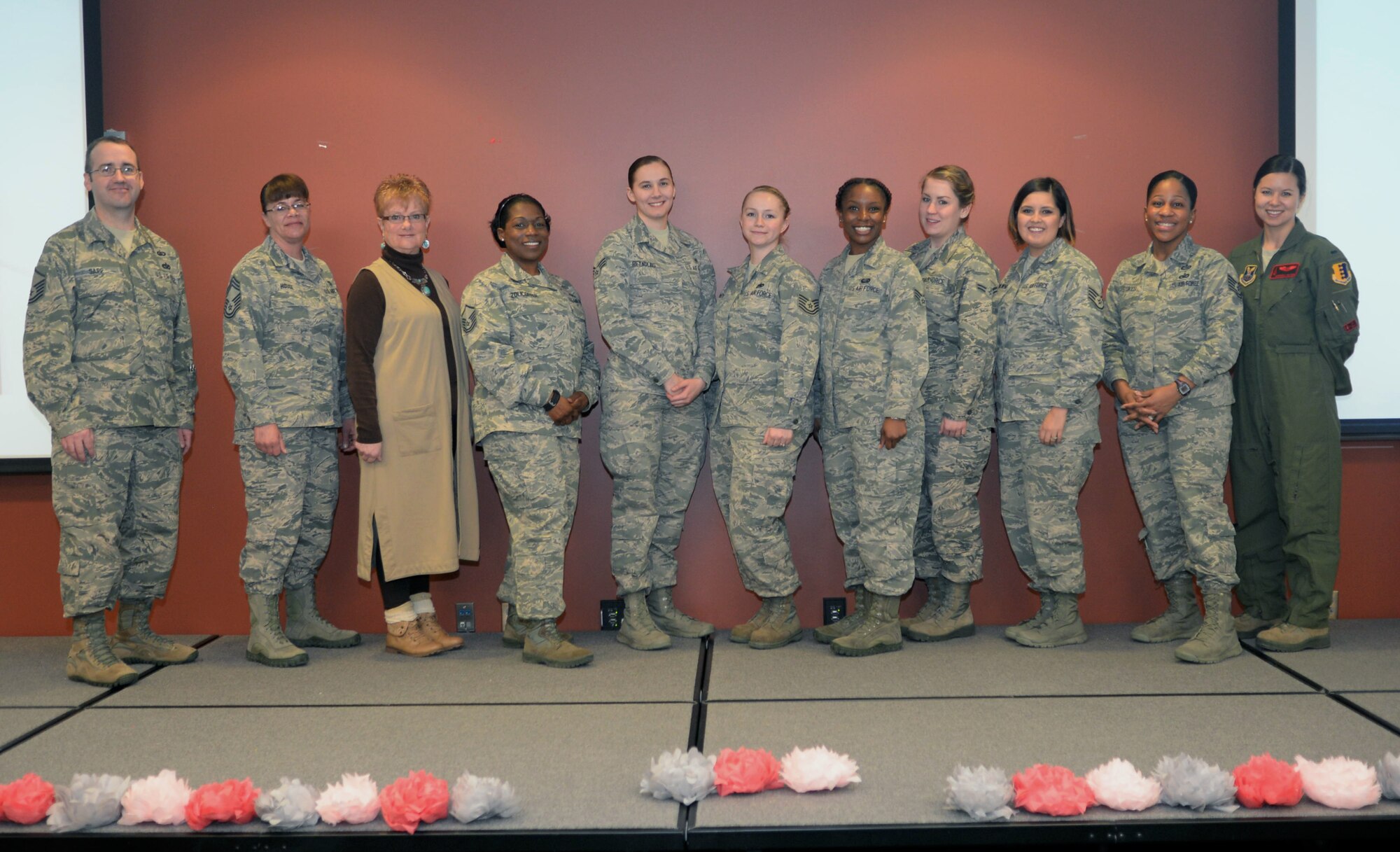 Attendees and guest speakers from the Women’s History Month luncheon pose for a photo inside the Deployment Center at Ellsworth Air Force Base, S.D., March 21, 2017. The luncheon was hosted by members of Ellsworth’s Diversity Council, and focused on the evolution of the role of women in the military and in society. (U.S. Air Force photo by Airman 1st Class Denise M. Jenson)