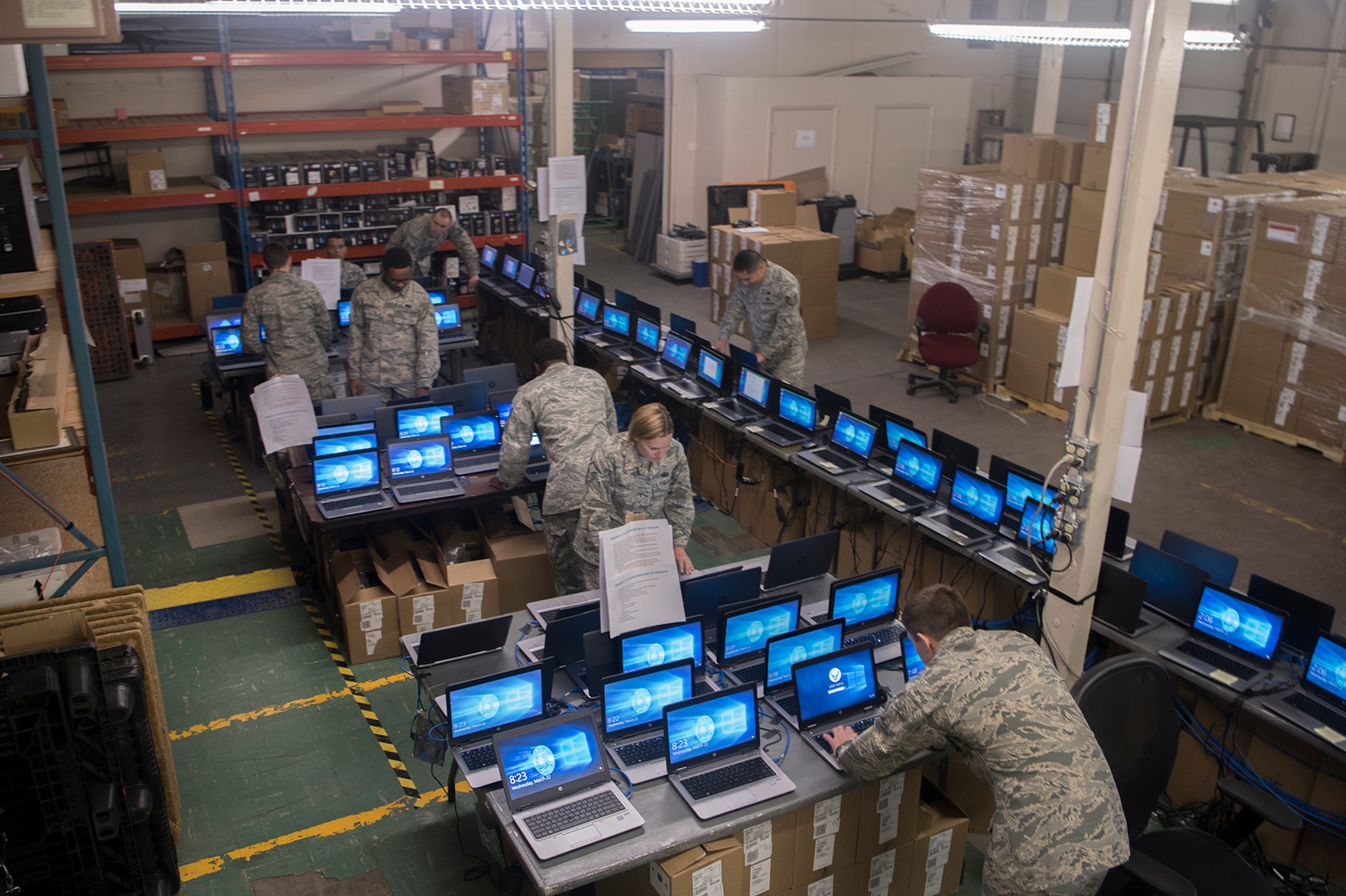 PETERSON AIR FORCE BASE, Colo. – Airmen of the 21st Communication Squadron work on several computers at once during the Windows 10 roll out project at Peterson Air Force Base, Colo., March 22, 2017. The Windows 10 roll out is part of a Department of Defense-wide mandate to update all computers across all services. The 21st CS has been working extra shifts to ensure that mandate is met well ahead of schedule on April 1. (U.S. Air Force photo by Steve Kotecki)