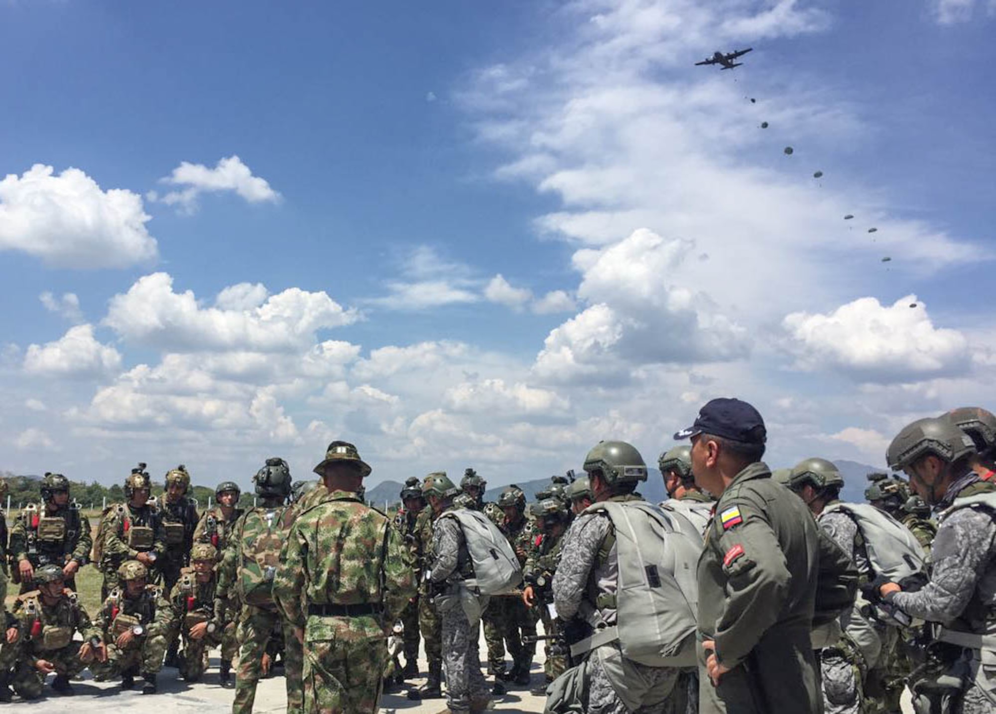 A Wyoming Air National Guard C-130 Hercules, air drops special forces from the U.S. Army, Colombian Army, Navy and Air Force during a training scenario in Bogota, Colombia. The 571st Mobility Support Advisory Squadron, alongside Airmen from five other squadrons spent three weeks training the Colombian forces in air operations, aeromedical evacuation, propeller balance, zodiac rigging and medical intelligence courses. (Courtesy Photo)