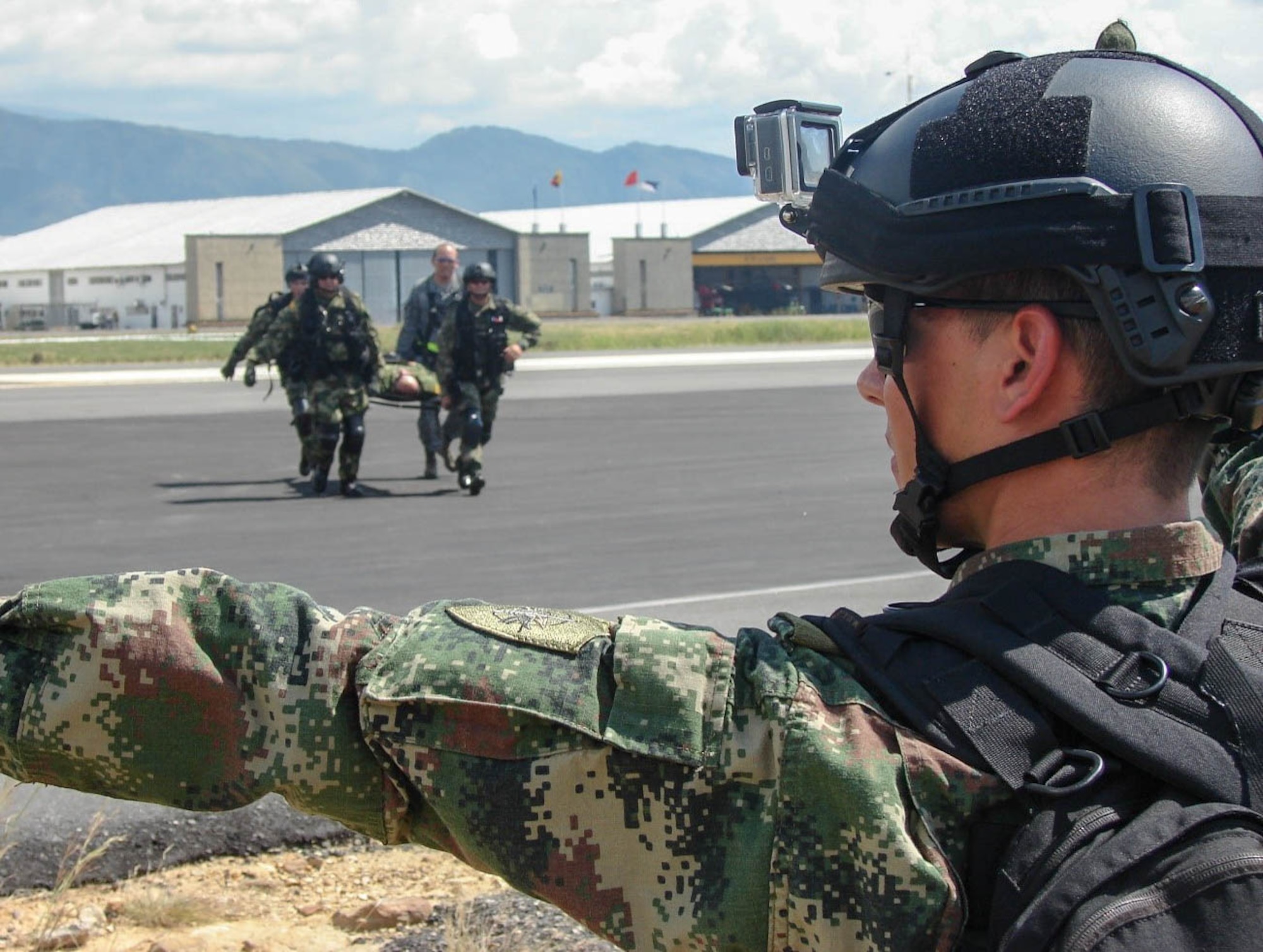 Service members from the Colombian Air Force and Army, transfer a simulated patient from a Colombian UH-60 Helicopter to a United States Air Force C-130 Hercules during a training scenario in Bogota, Colombia. The 571st Mobility Support Advisory Squadron, alongside Airmen from five other squadrons spent three weeks training the Colombian forces in air operations, aeromedical evacuation, propeller balance, zodiac rigging and medical intelligence courses. (Courtesy Photo)