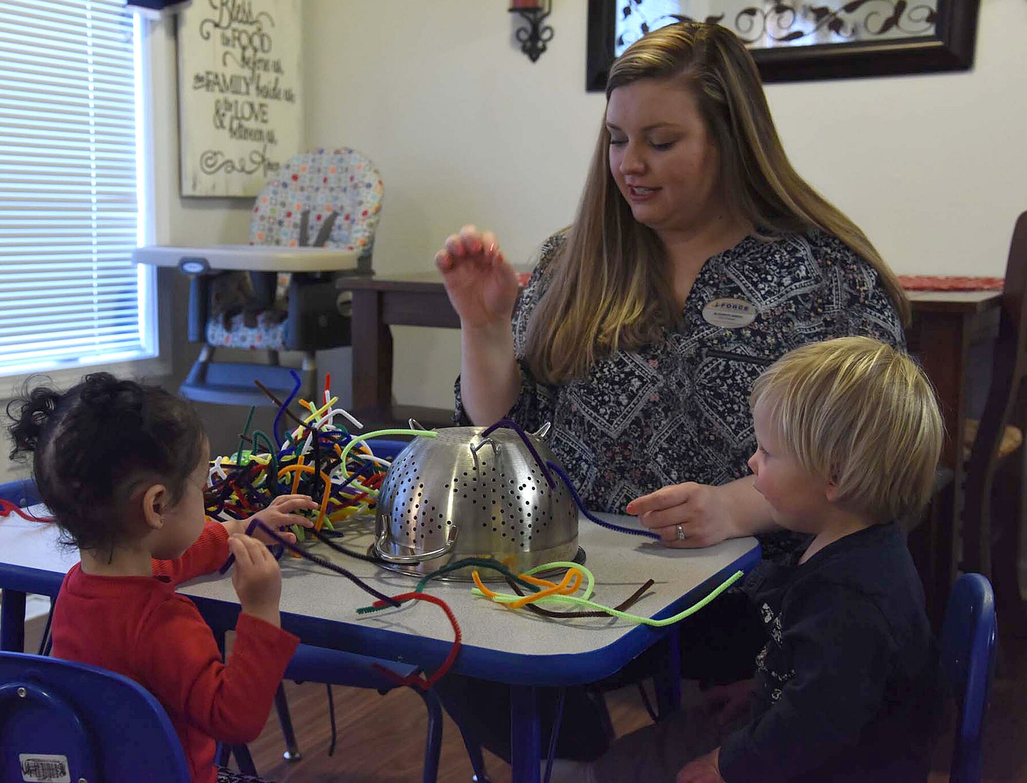 Liz Arrexi, 341st Force Support Squadron family child care home provider, plays a game with children to increase their motor skills March 24, 2017, at Malmstrom Air Force Base, Mont. Arrexi has been an FCC provider for a year and does it to support the mission of the base. (U.S. Air Force photo/Senior Airman Jaeda Tookes)