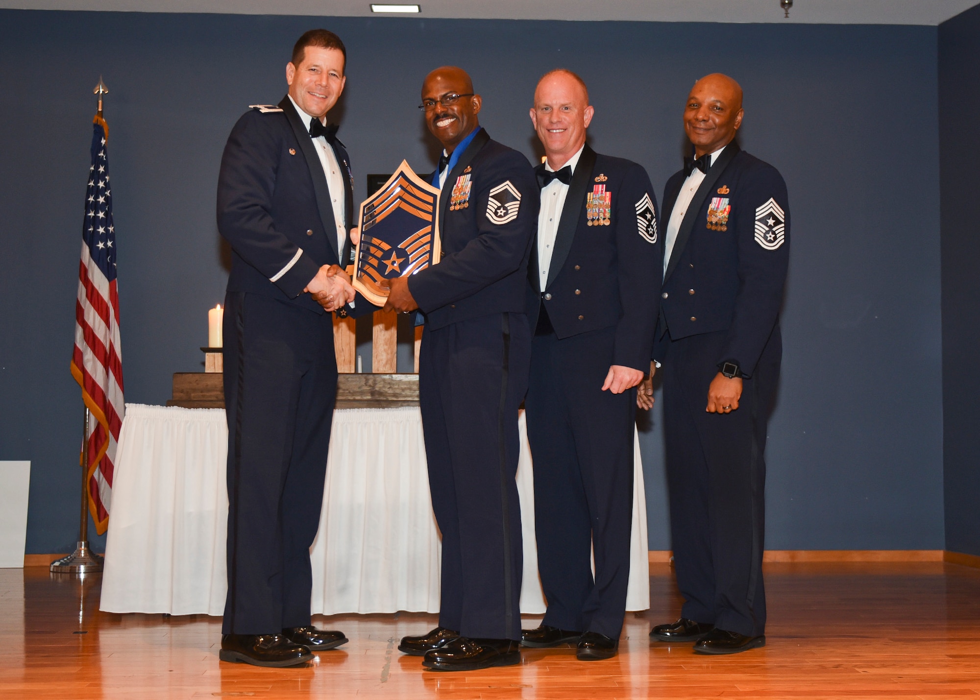 Senior Master Sgt. Max Walker, 43d Aircraft Maintenance Unit assistant superintendent receives a chief’s plaque and poses for a photo with Air Force Col. Michael Hernandez, 325th Fighter Wing commander, Chief Master Sgt. Frank Batten, 9th Air Force command chief and Chief Master Sgt. Craig Williams 325th FW command chief at the Horizons Community Center on Tyndall AFB, Fla., Feb. 7, 2017. Walker is one of 531 senior master sergeants selected for the rank of chief master sergeant. Walker credits many of his professional successes to his wingmen and the support of his family. (U.S. Air Force photo by Senior Airman Dustin Mullen/Released)