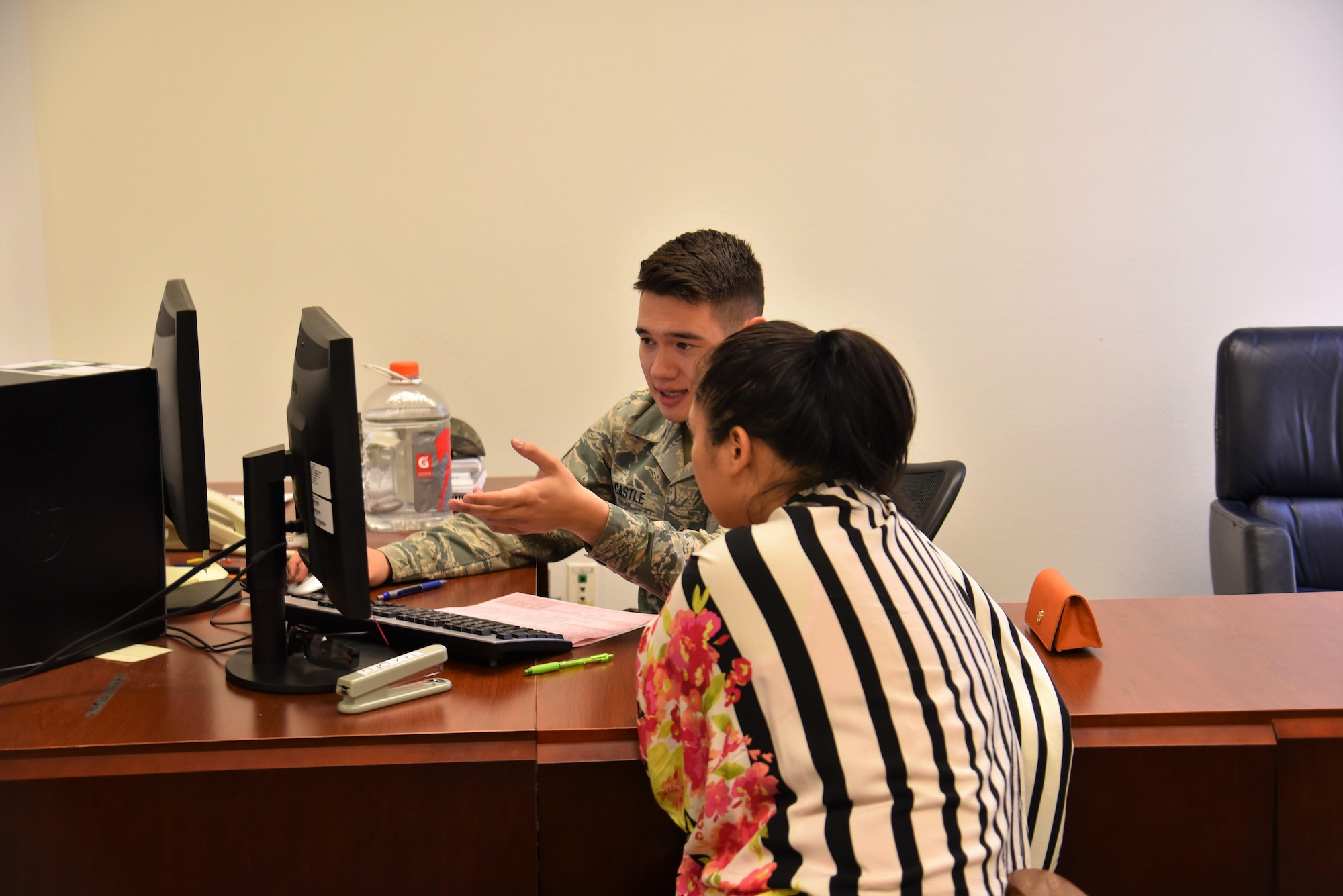 Senior Airman Michael Castle, 90th Missile Maintenance Squadron tax center volunteer, assists a customer in filing her taxes at F.E. Warren Air Force Base, Wyo., Mar. 23, 2017.  The tax center’s goal is to help service members, retirees and dependents file their taxes free of charge. Operating hours are Monday through Friday by appointment only until April 18, for more information please contact the Tax Center at 773-5829. (U.S. Air Force photo by 2nd Lt. Nikita Thorpe)