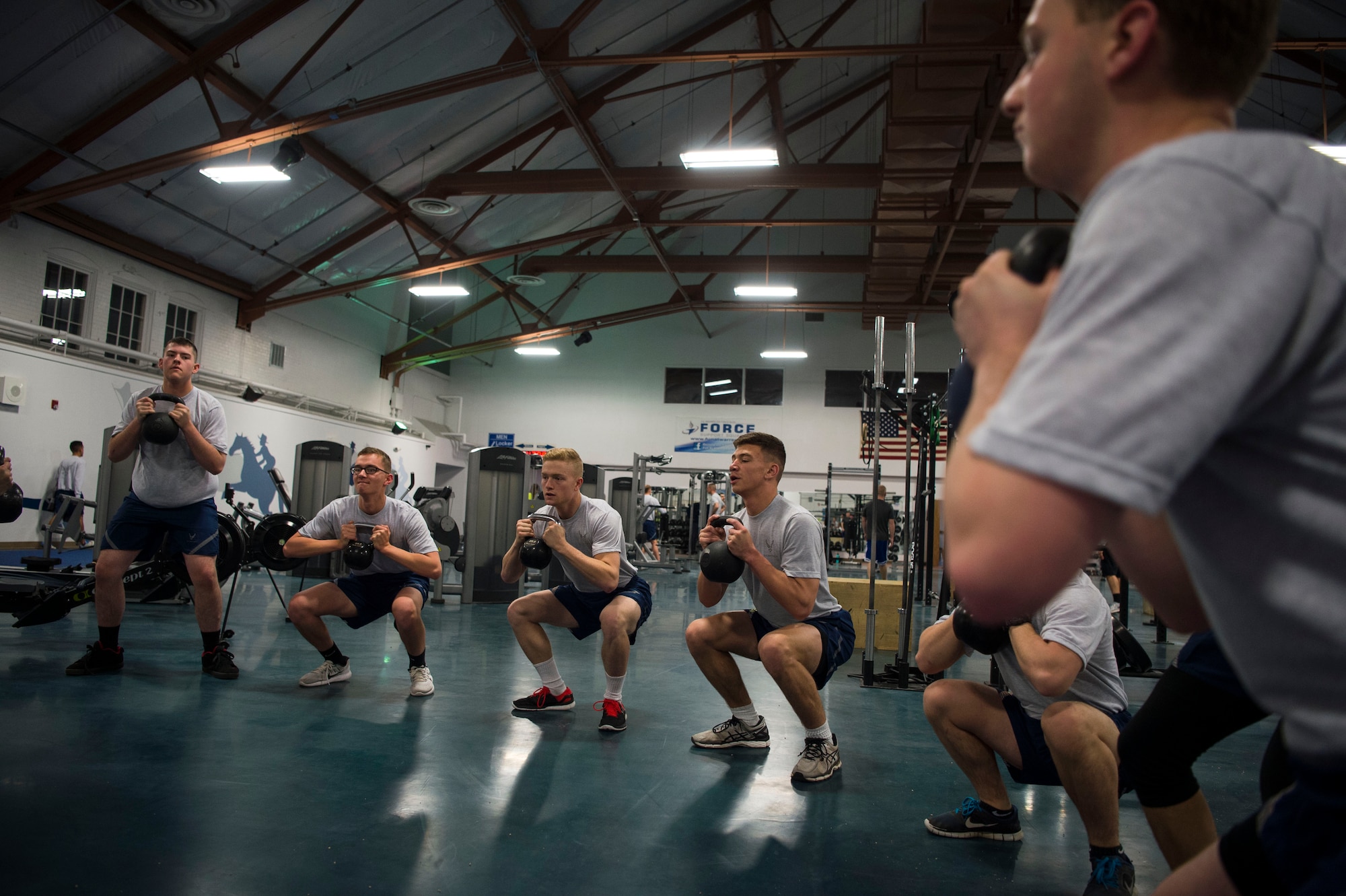 Members of the 790th Missile Security Forces Squadron perform kettlebell squats during squadron physical training on F.E. Warren Air Force Base, Wyo., Feb. 1, 2017. The 790th MSFS performs a multitude of workouts focusing on cardio and muscular fitness. (U.S. Air Force photo by Staff Sgt. Christopher Ruano)