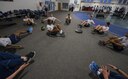 Senior Airman Tyle Fields, 790th Missile Security Forces Squadron physical training leader, leads members of the 790th MSFS in a frog crunch exercise during squadron physical training on F.E. Warren Air Force Base, Wyo., Feb. 1, 2017. Fields plans and executes his fitness training plan for his squadron and prepares his team members to pass their PT test or to deploy. (U.S. Air Force photo by Staff Sgt. Christopher Ruano)