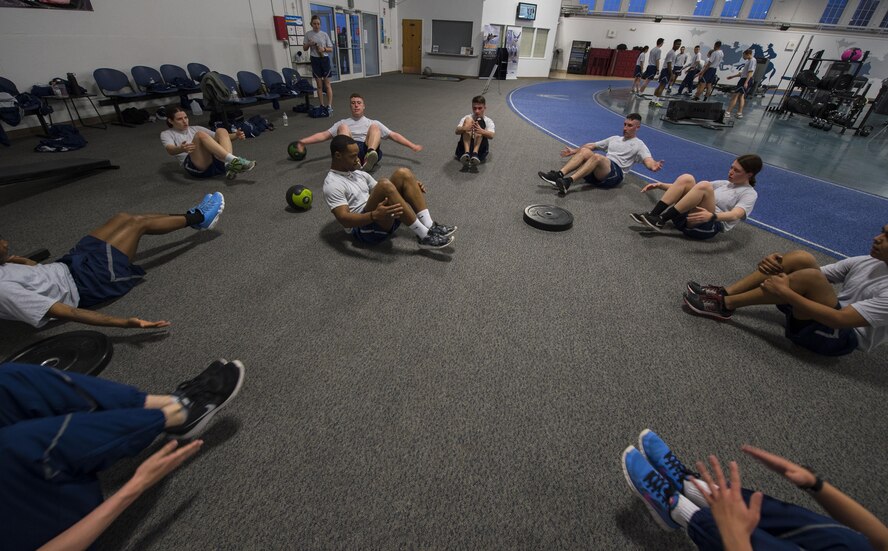 Senior Airman Tyle Fields, 790th Missile Security Forces Squadron physical training leader, leads members of the 790th MSFS in a frog crunch exercise during squadron physical training on F.E. Warren Air Force Base, Wyo., Feb. 1, 2017. Fields plans and executes his fitness training plan for his squadron and prepares his team members to pass their PT test or to deploy. (U.S. Air Force photo by Staff Sgt. Christopher Ruano)