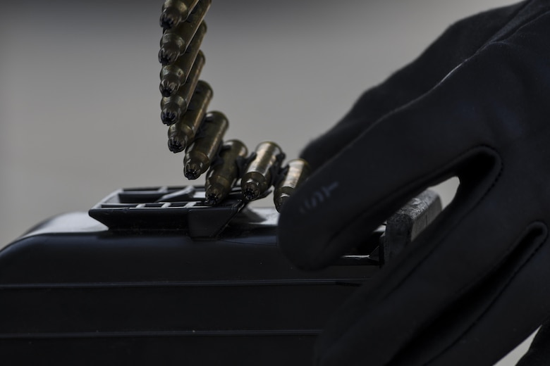 A Defender from the 51st Security Forces Squadron loads an M240 machine gun ammo pouch during a field training exercise at Osan Air Base, Republic of Korea, March 23, 2017. The field training exercise was one of the final parts of the 51st SFS Combat Readiness Course, where Defenders spend 10 days expanding their knowledge on defending the base, executing contingency operations and sustaining the force. (U.S. Air Force photo by Staff Sgt. Victor J. Caputo)