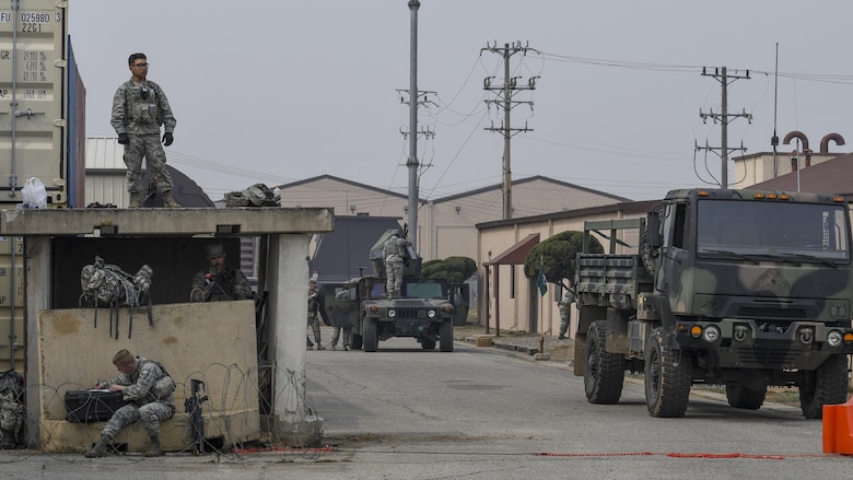 Defenders from the 51st Security Forces Squadron settle into a defensive fighting position during a field training exercise at Osan Air Base, Republic of Korea, March 23, 2017. The field training exercise was part of the 51st SFS Combat Readiness Course, which helps enlisted Defenders of all ranks understand their role in supporting the base and maintaining the ability to “Fight Tonight.” (U.S. Air Force photo by Staff Sgt. Victor J. Caputo)