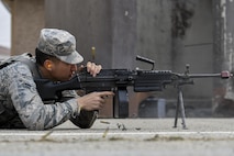 U.S. Air Force Airman 1st Class Alexander Choi, 51st Security Forces Squadron turret gunner, test fires several blank rounds from an M240 machine gun during a field training exercise at Osan Air Base, Republic of Korea, March 23, 2017. The field training exercise was one of the final parts of the 51st SFS Combat Readiness Course, where Defenders spend 10 days expanding their knowledge on defending the base, executing contingency operations and sustaining the force. (U.S. Air Force photo by Staff Sgt. Victor J. Caputo)