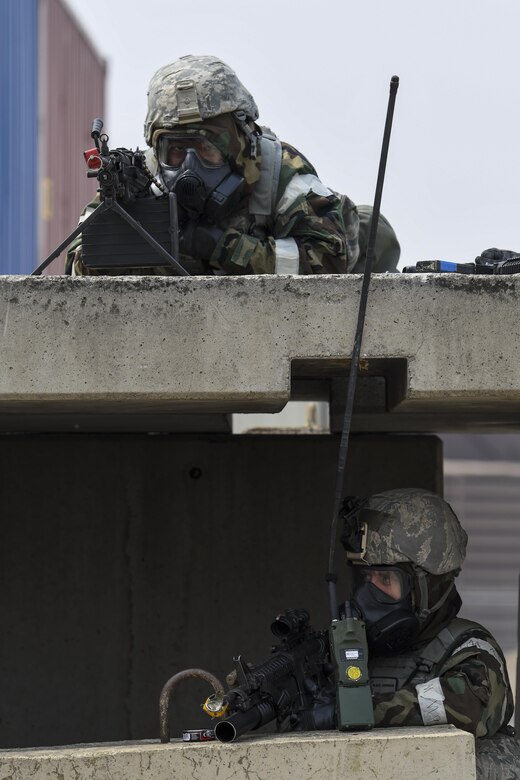 Two Defenders from the 51st Security Forces Squadron man a defensive fighting position during a field training exercise at Osan Air Base, Republic of Korea, March 23, 2017. The field training exercise was part of the 51st SFS Combat Readiness Course, which helps enlisted Defenders of all ranks understand their role in supporting the base and maintaining the ability to “Fight Tonight.” (U.S. Air Force photo by Staff Sgt. Victor J. Caputo)