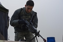 U.S. Air Force Airman 1st Class Alexander Choi, 51st Security Forces Squadron turret gunner, prepares an M240 machine gun during a field training exercise at Osan Air Base, Republic of Korea, March 23, 2017. The field training exercise was one of the final parts of the 51st SFS Combat Readiness Course, where Defenders spend 10 days expanding their knowledge on defending the base, executing contingency operations and sustaining the force. (U.S. Air Force photo by Staff Sgt. Victor J. Caputo)