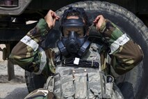 U.S. Air Force Staff Sgt. Prince Johnson, 51st Security Forces Squadron Defender, dons his gas mask during a field training exercise at Osan Air Base, Republic of Korea, March 23, 2017. Johnson was part of a group of Defenders who went through the 51st SFS Combat Readiness Course, a 10-day program that covers basic and advanced contingency operations and base-specific defense tactics, including the use of Mission Oriented Protective Posture gear. (U.S. Air Force photo by Staff Sgt. Victor J. Caputo)