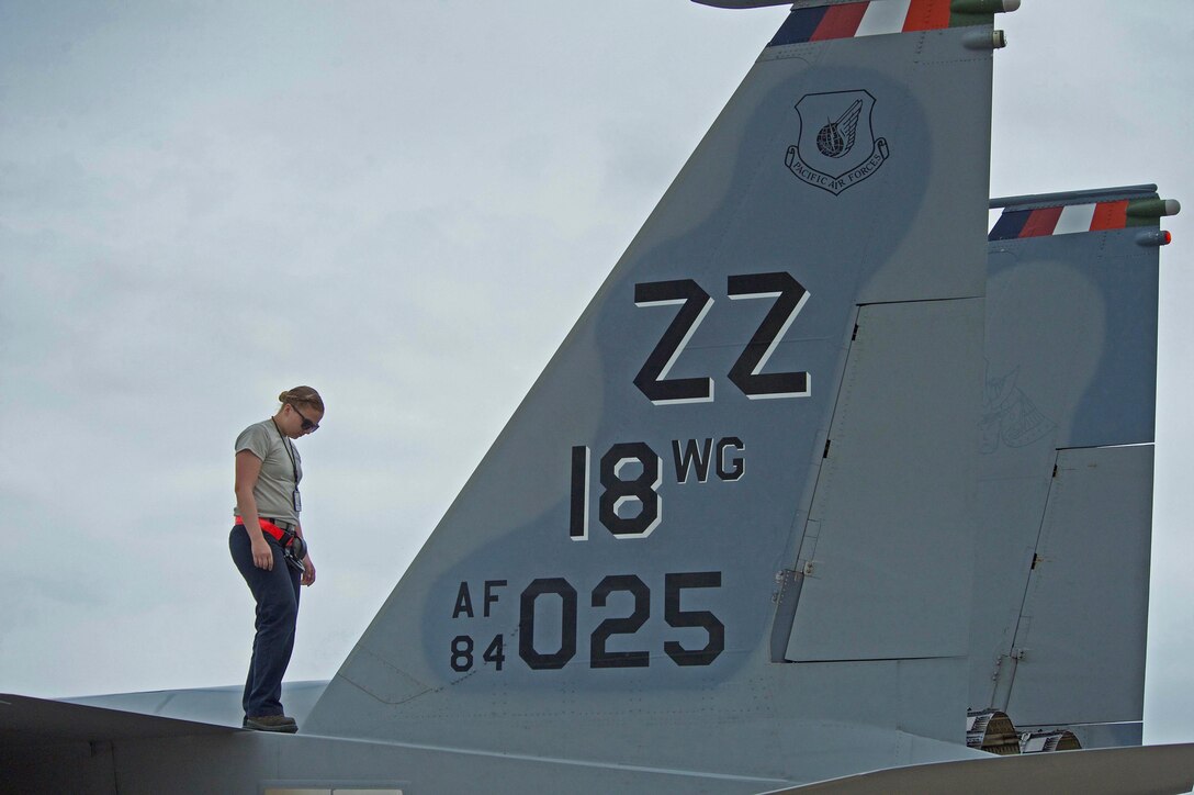 U.S. Air Force Airman First Class Mardee Holmes, assigned to the 18th Wing from Kadena Air Force Base, Japan, performs a thru-flight inspection of the top of an F-15, which ensures the aircraft is safe for flight, during exercise Cope Tiger 17 (CT) at Korat Royal Thai Air Force Base, Thailand, March 27, 2017. The annual multilateral exercise, which involves a combined total of 76 aircraft and 43 air defense assets, is aimed at improving combined combat readiness and interoperability between the Republic of Singapore air force, Royal Thai air force, and U.S. Air Force, while concurrently enhancing the three nations' military relations. (U.S. Air Force photo by Staff Sgt. Kamaile Chan)