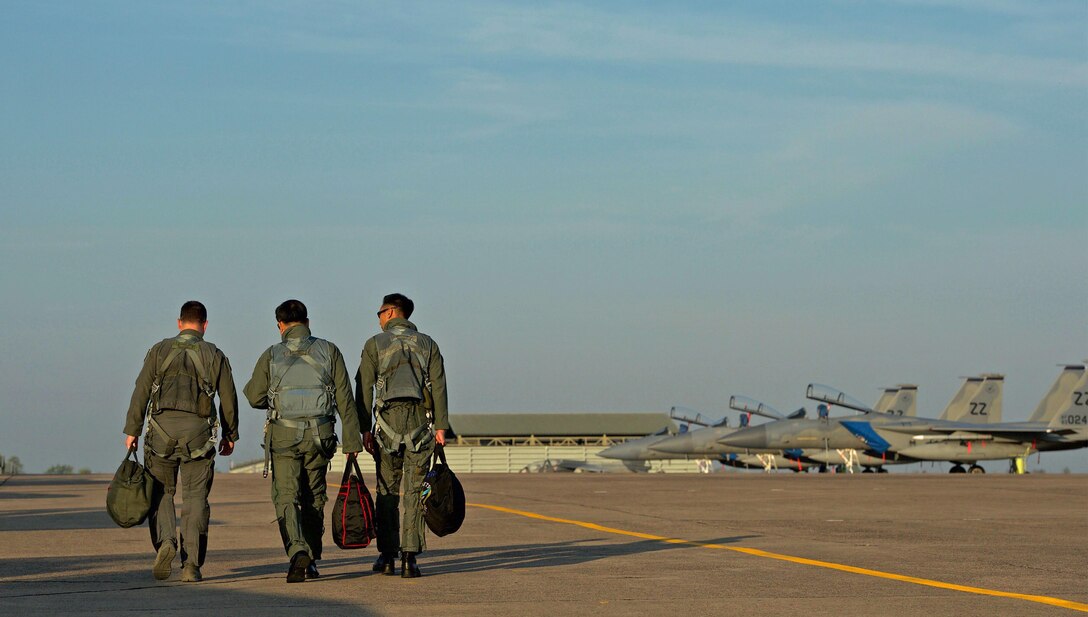 U.S. Air Force Lt. Col. James McFarland (left), Royal Thai air force Group Capt. Supijjarn Thamwatharsaree (center) and Republic of Singapore air force Col. Chan Ching Hao, exercise directors for Cope Tiger 17 (CT17) walk along the flightline during CT17 at Korat Royal Thai Air Force Base, Thailand, March 28, 2017. The annual multilateral exercise, which involves a combined total of 76 aircraft and 43 air defense assets, is aimed at improving combined combat readiness and interoperability between the Republic of Singapore air force, Royal Thai air force, and U.S. Air Force, while concurrently enhancing the three nations' military relations. (U.S. Air Force photo by Staff Sgt. Kamaile Chan)