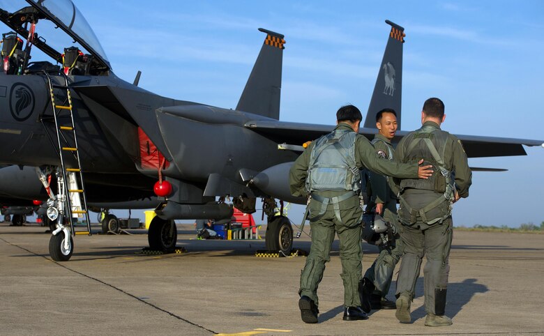 Royal Thai air force Group Capt. Supijjarn Thamwatharsaree (left), Republic of Singapore air force Col. Chan Ching Hao (center) and U.S. Air Force Lt. Col. James McFarland walk along the flightline during exercise Cope Tiger 17 at Korat Royal Thai Air Force Base, Thailand, March 28, 2017. The annual multilateral exercise, which involves a combined total of 76 aircraft and 43 air defense assets, is aimed at improving combined combat readiness and interoperability between the Republic of Singapore air force, Royal Thai air force, and U.S. Air Force, while concurrently enhancing the three nations' military relations. (U.S. Air Force photo by Staff Sgt. Kamaile Chan)