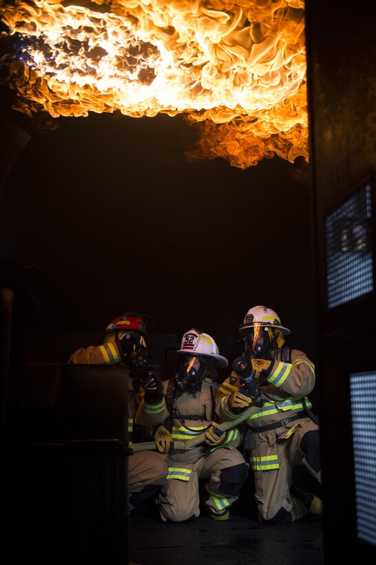 Airmen from the 52nd Mission Support Group experience a rollover fire during a live fire exercise at Spangdahlem Air Base, Germany, March 23, 2017. A rollover fire happens when gasses from a fire in a room or enclosed area rise to the ceiling and ignite. (U.S. Air Force photo by Airman First Class Preston Cherry)