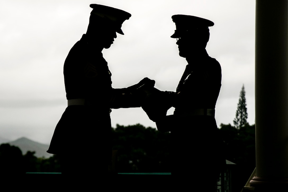 Marine Corps Staff Sgt. Kendrix D. Graham and Sgt. Michael J. Black fold an American flag during the memorial service for retired Marine Corps Col. Vincil W. Hazelbaker at Hawaiian Memorial Park Cemetery in Kaneohe, Hawaii, March 24, 2017. After the ceremony, Marine helicopters conducted a missing man formation for the aviator who served 34 years in the military. Hazelbaker flew more than 680 combat missions and earned the Navy Cross for heroism during the Vietnam War. Marine Corps photo by Sgt. Brittney Vella