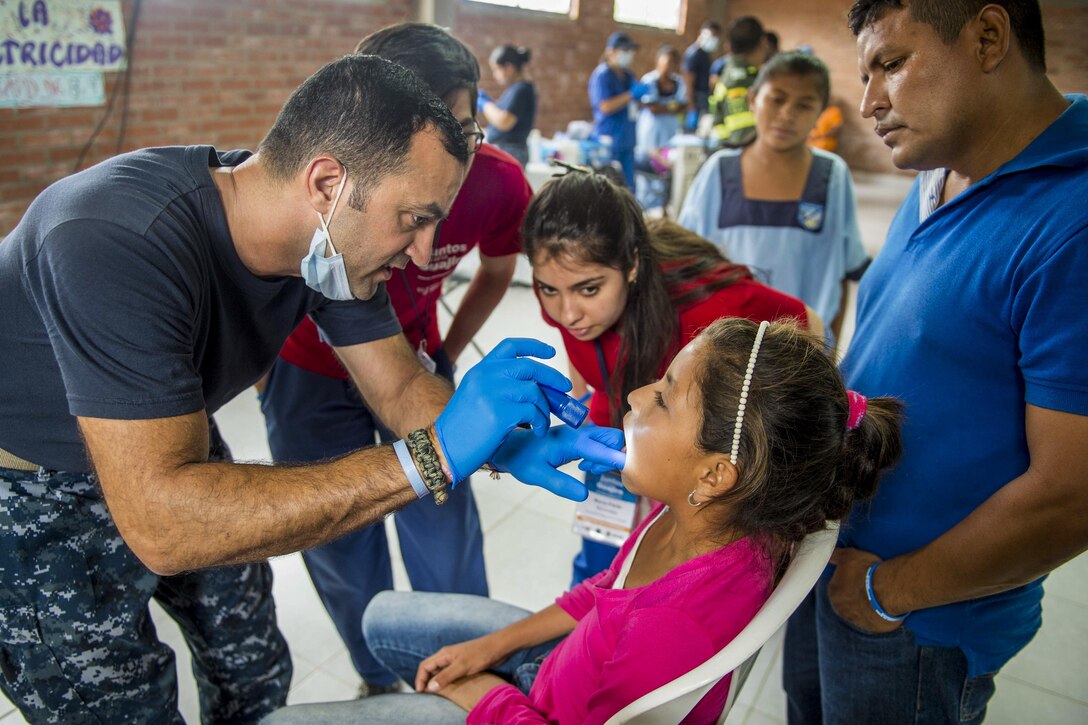 Navy Lt. Farid Hamidzadeh performs an oral exam on a patient at the Continuing Promise 2017 medical site in Mayapo, Colombia, March 25, 2017. The civil-military operation includes humanitarian assistance, training engagements, and medical, dental, and veterinary aid to show U.S. support and commitment to Central and South America. Hamidzadeh is attached to Naval Hospital Jacksonville, Fla. Navy photo by Petty Officer 2nd Class Shamira Purifoy