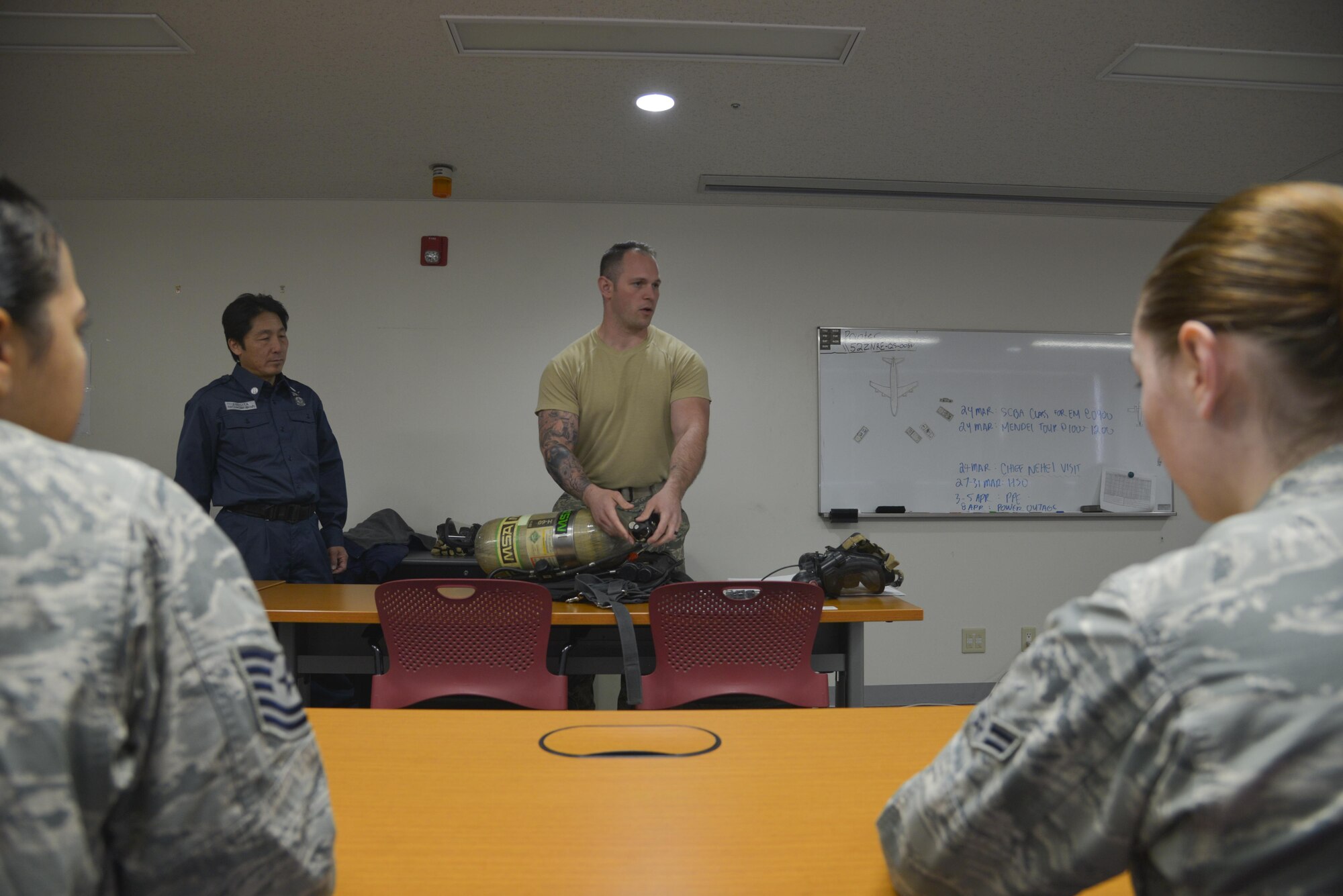 Staff Sgt. Colin Huffaker, 374th Civil Engineer Squadron fire emergency services crew chief, briefs personnel on how to properly use a Self-Contained Breathing Apparatus at Yokota Air Base, Japan, March 24, 2017. The briefing entailed how to properly put together the SCBA, inspect the piece of equipment and how to use it. (U.S. Air Force photo by Staff Sgt. David Owsianka)