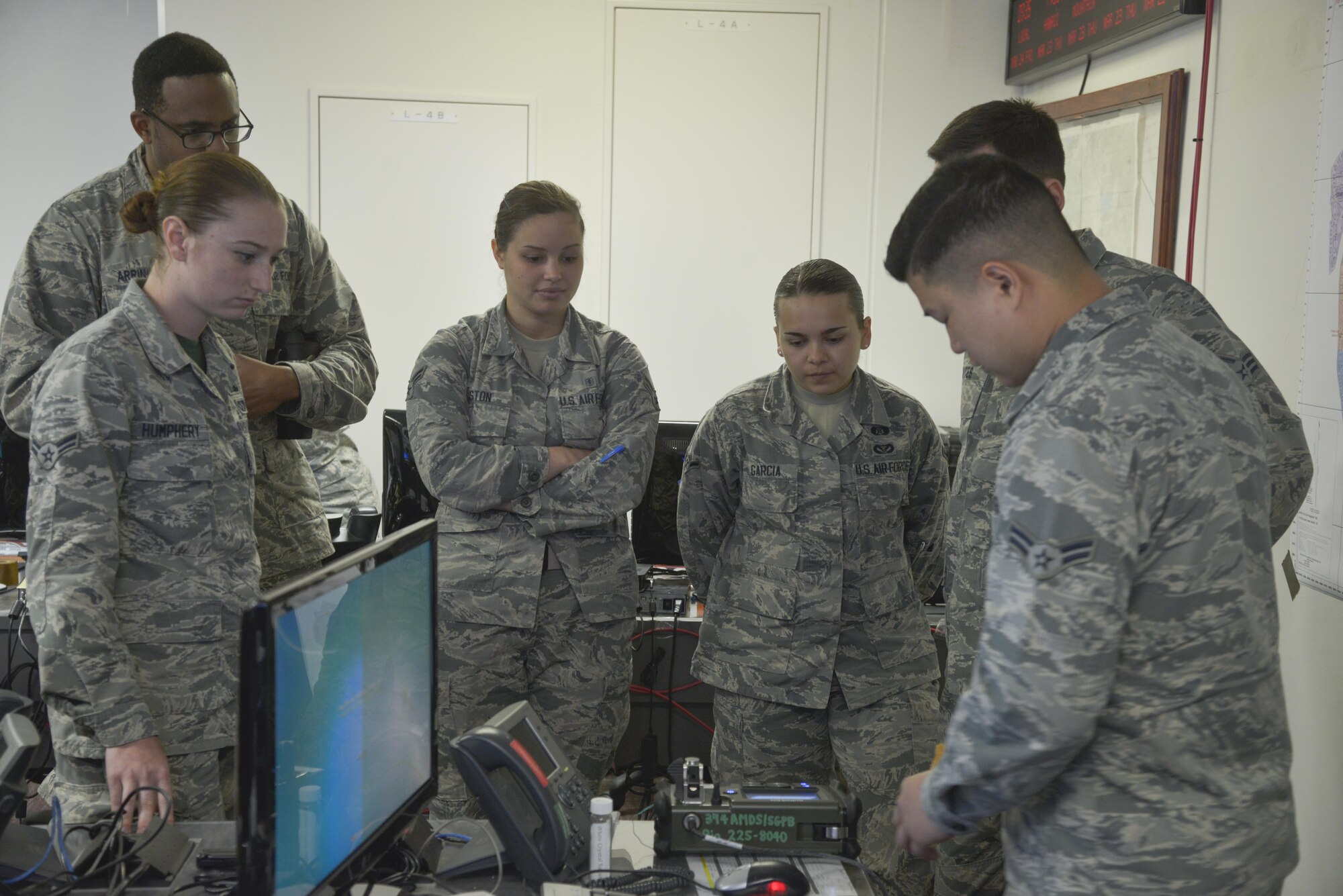 Airman 1st Class Dong Han, 374th Aerospace Medical Squadron bioenvironmental engineering technician, discusses how to properly use a HazMatID elite device to detect unknown chemical and biological agents at Yokota Air Base, Japan, March 24, 2017. The bioenvironmental section also provided briefings on their mission in the emergency operation center and chemical attack references. (U.S. Air Force photo by Staff Sgt. David Owsianka)
