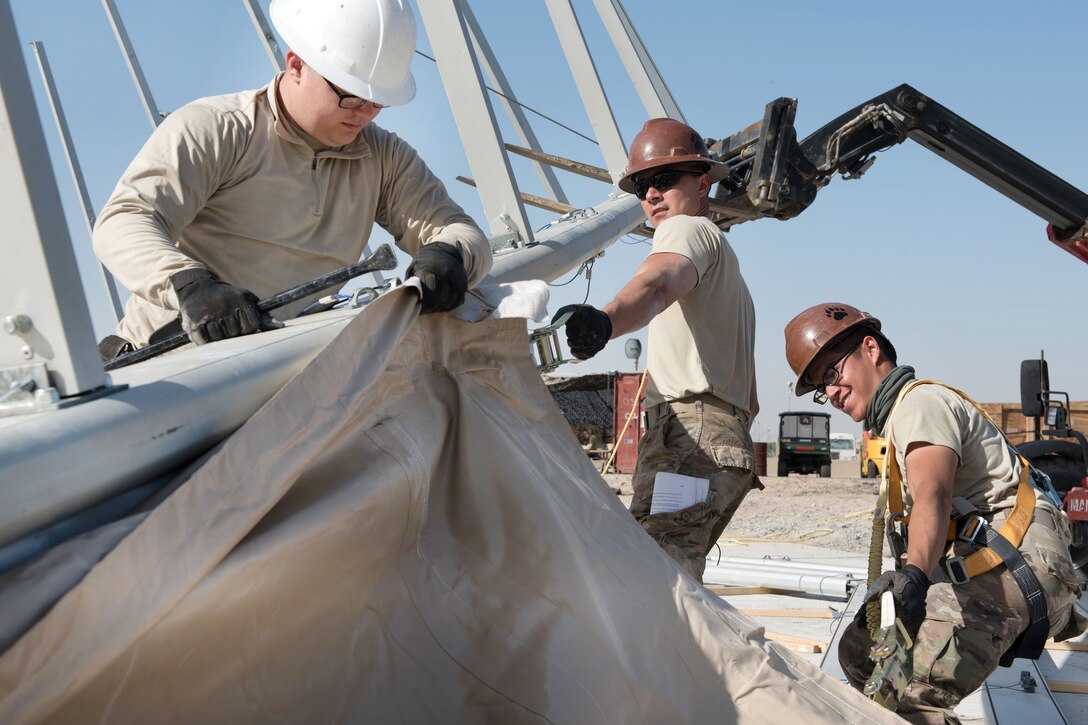 Airmen install canvas onto a shelter dome for the 407th Air Expeditionary Group at an undisclosed location in U.S. Central Command's area of operations, March 21, 2017. Air Force photo by Master Sgt. Benjamin Wilson