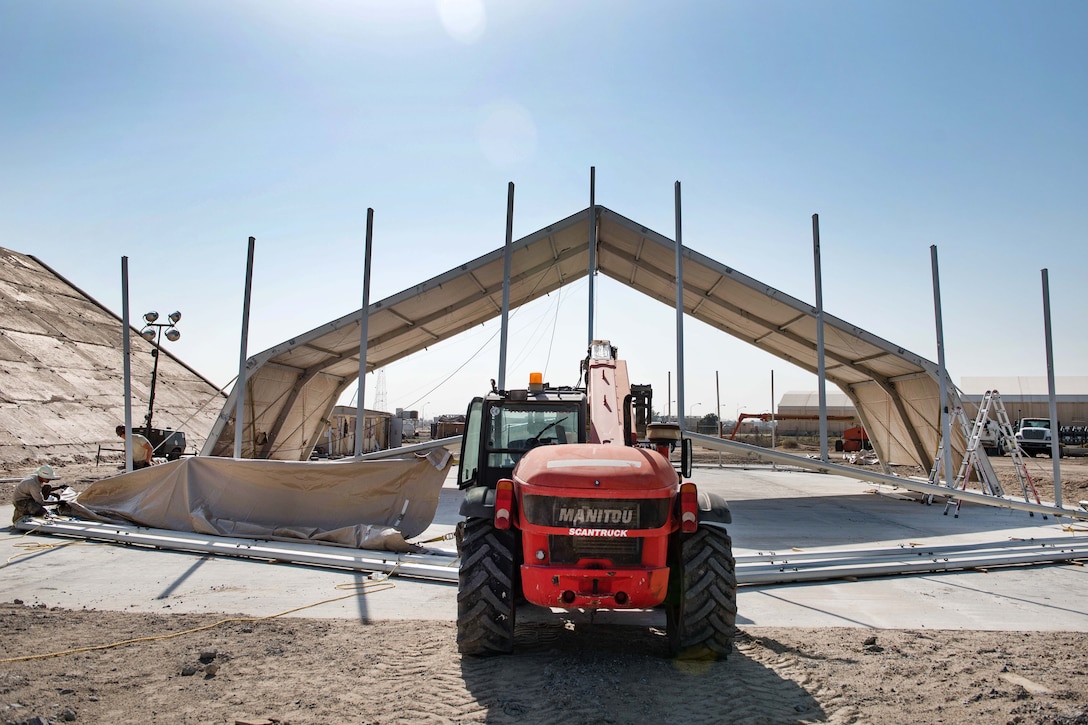 Airmen work to complete installing canvas onto a shelter dome for the 407th Air Expeditionary Group at an undisclosed location in U.S. Central Command's area of operations, March 21, 2017. Air Force photo by Master Sgt. Benjamin Wilson